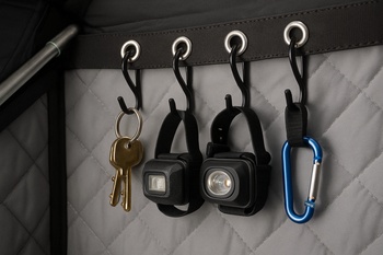 Jackets and pants hanging from hooks in a shelter corner