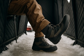 Boots making small ankle circles in a narrow shelter aisle