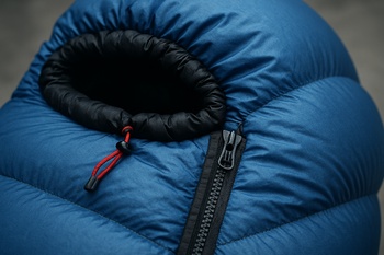 Winter sleeping bag partially zipped with hood open