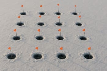 Angler checking sonar over a staggered staircase grid of ice holes